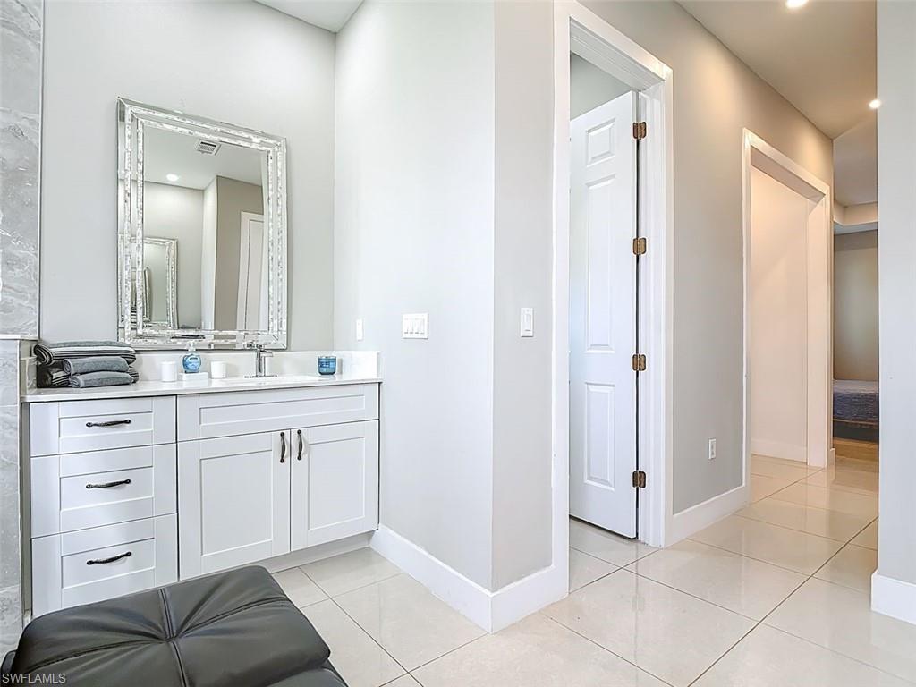 1806 41st Street Southwest Naples, FL 34116 - Photo 12 of 27 a spacious bathroom with a sink a mirror and a shower