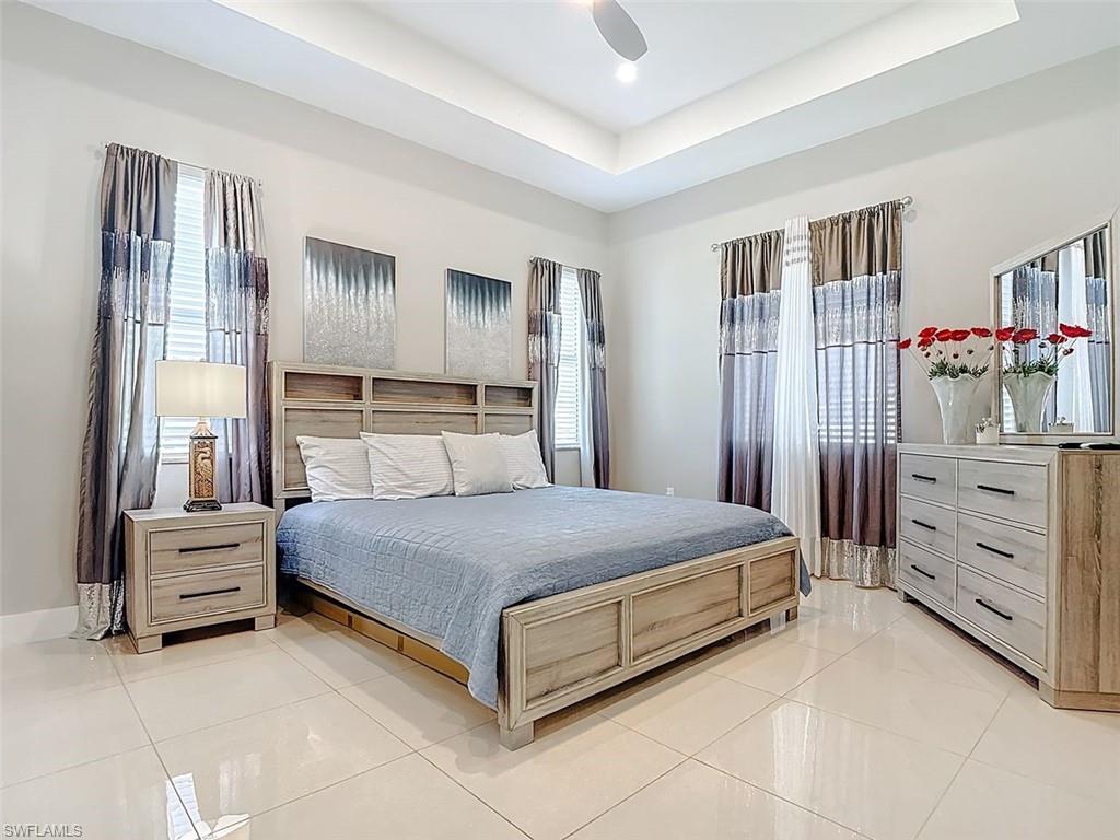 1806 41st Street Southwest Naples, FL 34116 - Photo 15 of 27 a bedroom with a bed and a cabinets