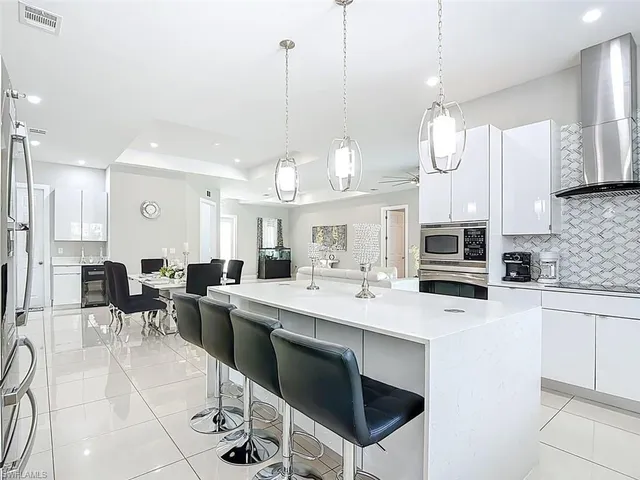 a large kitchen with a table and chairs