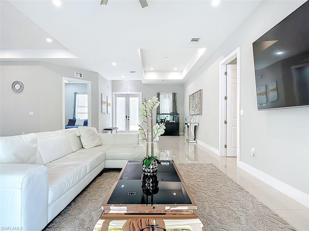 1806 41st Street Southwest Naples, FL 34116 - Photo 19 of 27 a living room with furniture and a dining table