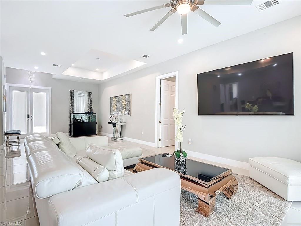 1806 41st Street Southwest Naples, FL 34116 - Photo 20 of 27 a living room with furniture and a flat screen tv