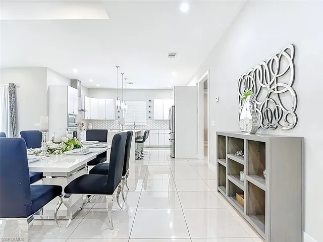 a living room with furniture and a kitchen view