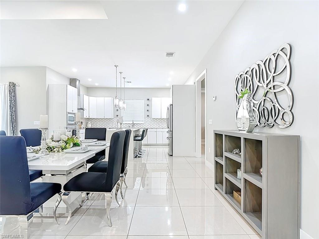 1806 41st Street Southwest Naples, FL 34116 - Photo 21 of 27 a living room with furniture and a kitchen view