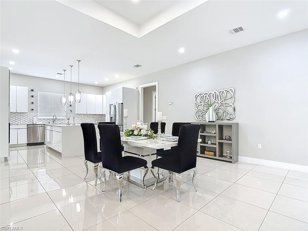 1806 41st Street Southwest Naples, FL 34116 - Photo 23 of 27 a view of kitchen with cabinets and outdoor space