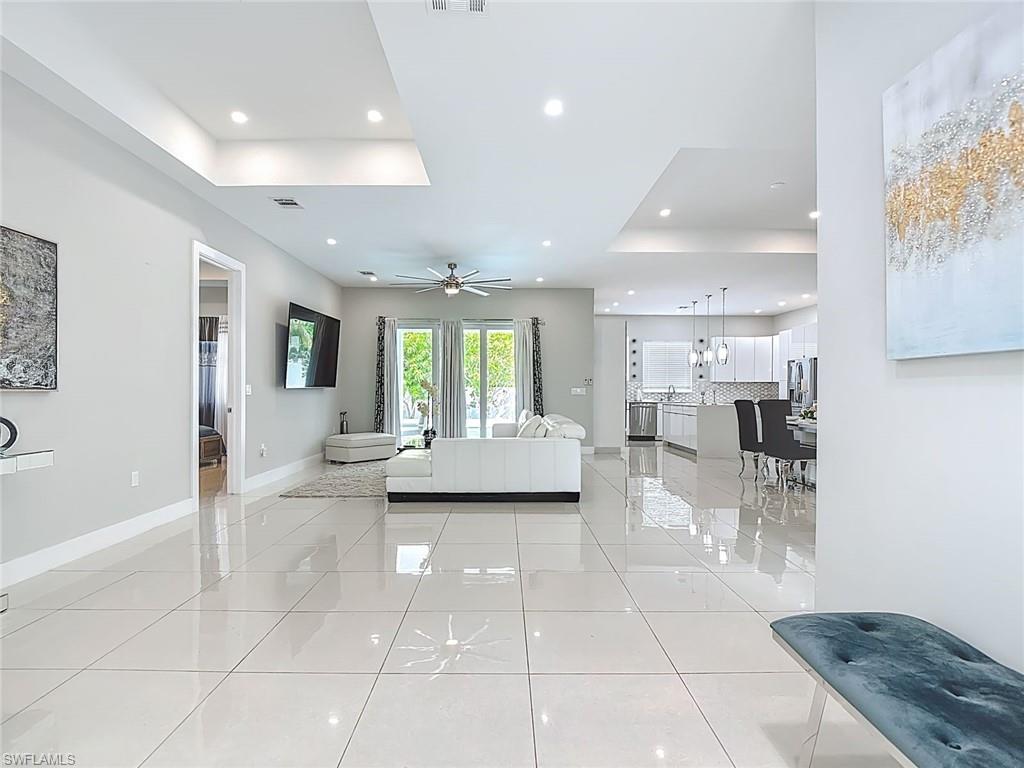1806 41st Street Southwest Naples, FL 34116 - Photo 25 of 27 a view of a living room and kitchen with a large window