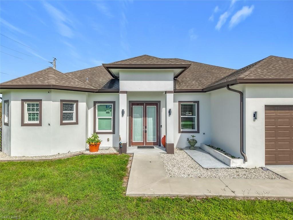 1806 41st Street Southwest Naples, FL 34116 - Photo 27 of 27 a front view of a house with garden