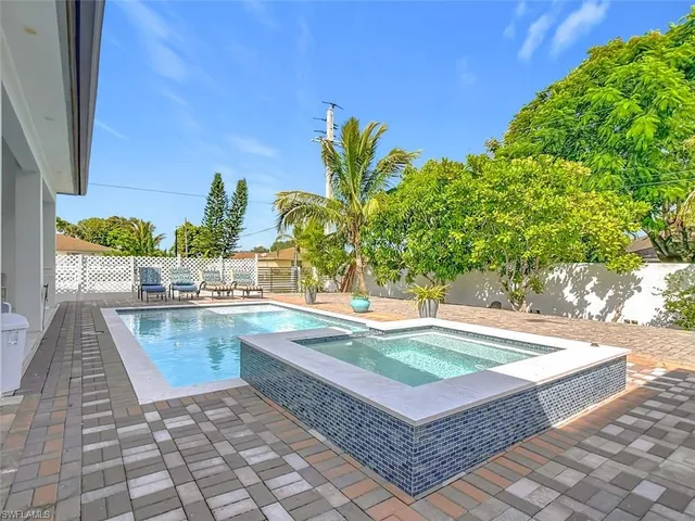 a view of a backyard with plants and a patio