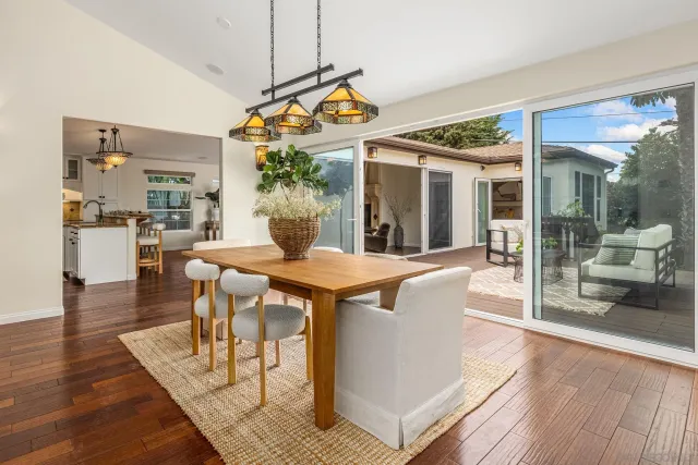 a view of a dining room with furniture wooden floor and a chandelier