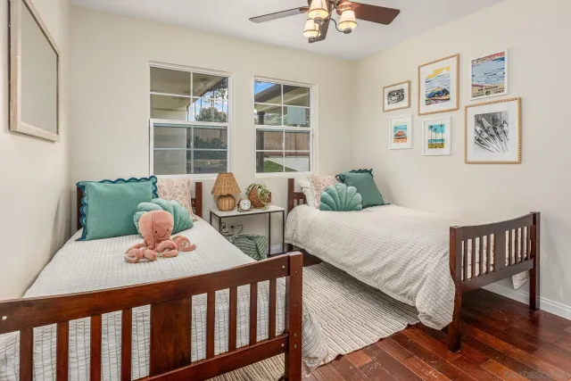 a bedroom with furniture and wooden floor