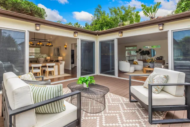 a view of a patio with a dining table and chairs