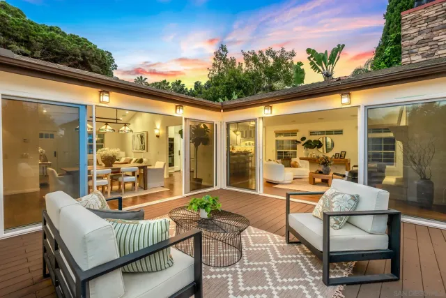 a balcony with furniture and a potted plant