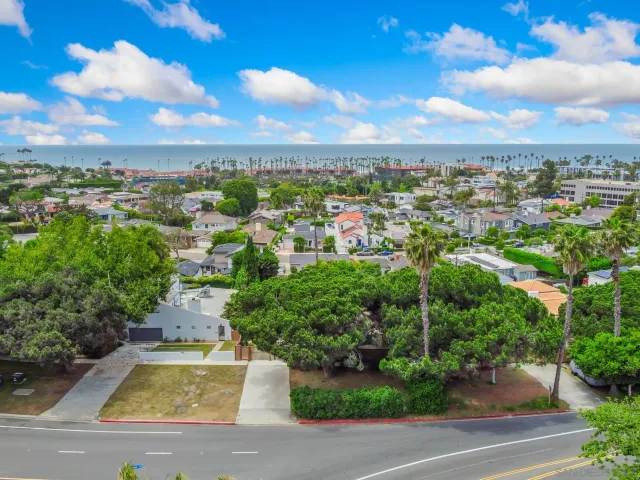 an aerial view of residential houses with city view