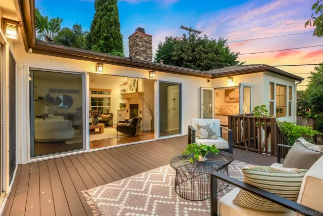 a view of a patio with couches table and chairs and potted plants