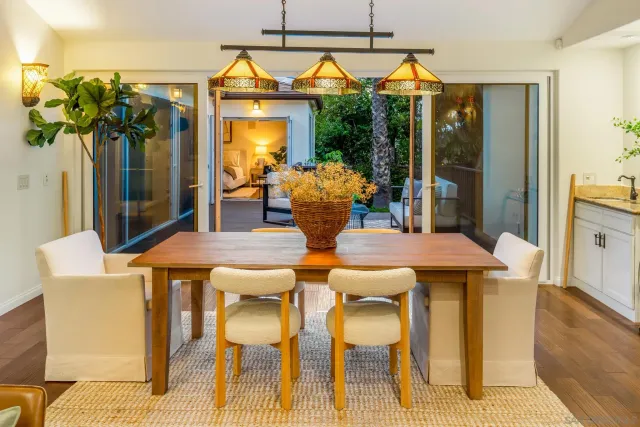 a view of a dining room with furniture and chandelier