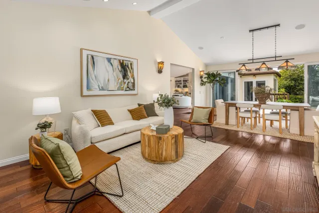 a living room with furniture wooden floor and dining table