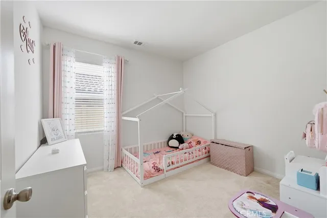 a bedroom with a bed and flat screen tv