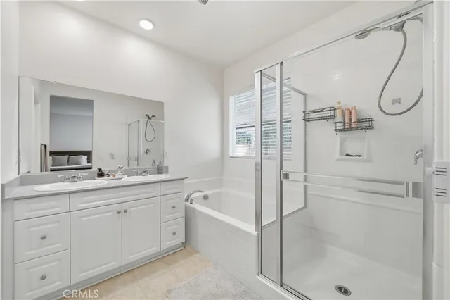 a bathroom with a granite countertop toilet a sink a mirror and a window