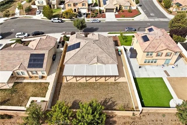an aerial view of a house with yard swimming pool and outdoor seating