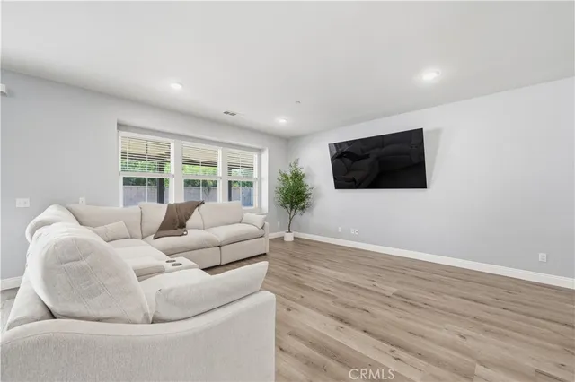 a living room with furniture tv and a flat screen tv