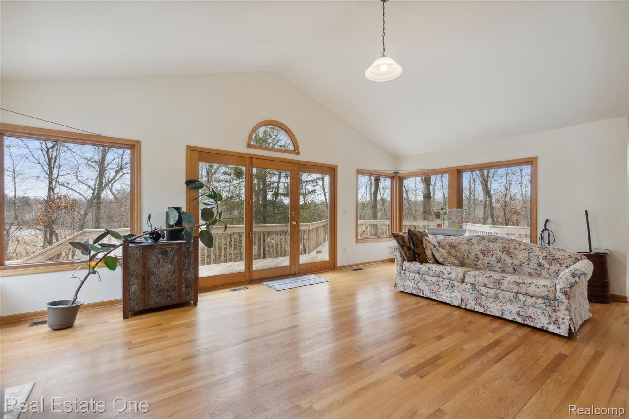7827 Hammel Road Brighton, MI 48116 - Photo 13 of 33 Wall of Windows ~ Hardwood Flooring