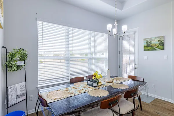 a view of a dining room with furniture and wooden floor