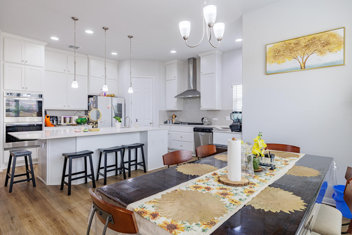 1913 Equine Road Leander, TX 78641 - Photo 16 of 35 a kitchen with stainless steel appliances granite countertop a dining table chairs and view of kitchen