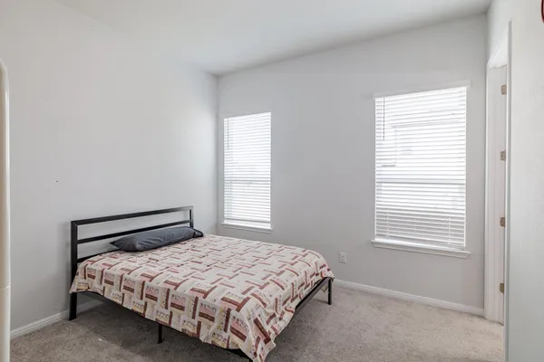 a bedroom with a bed and window