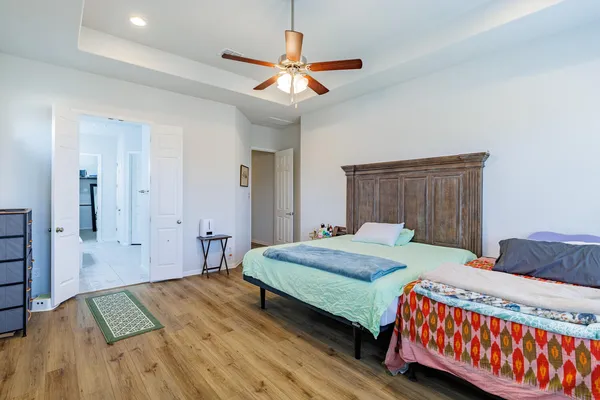 a bedroom with a bed and a chandelier
