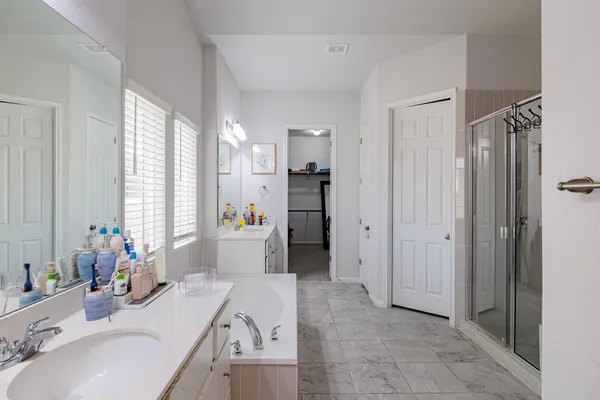 a bathroom with a sink vanity tub and shower
