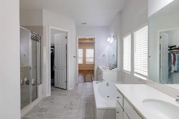 a en suite bathroom with a granite countertop sink and a mirror