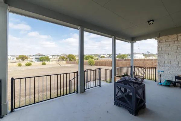 a living room with furniture and floor to ceiling windows
