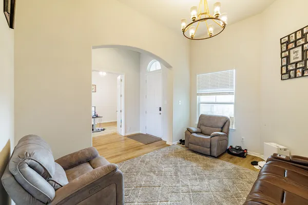 a living room with furniture chess board and a window