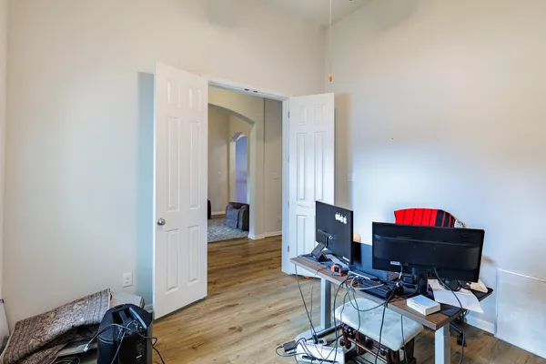 a view of a workspace with furniture and wooden floor