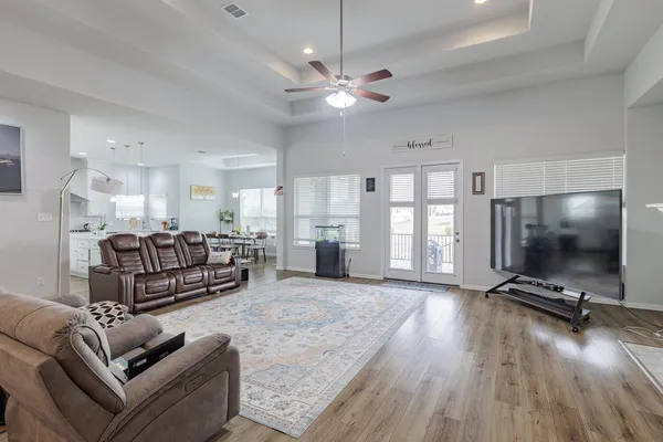 a living room with furniture gym equipment and a flat screen tv