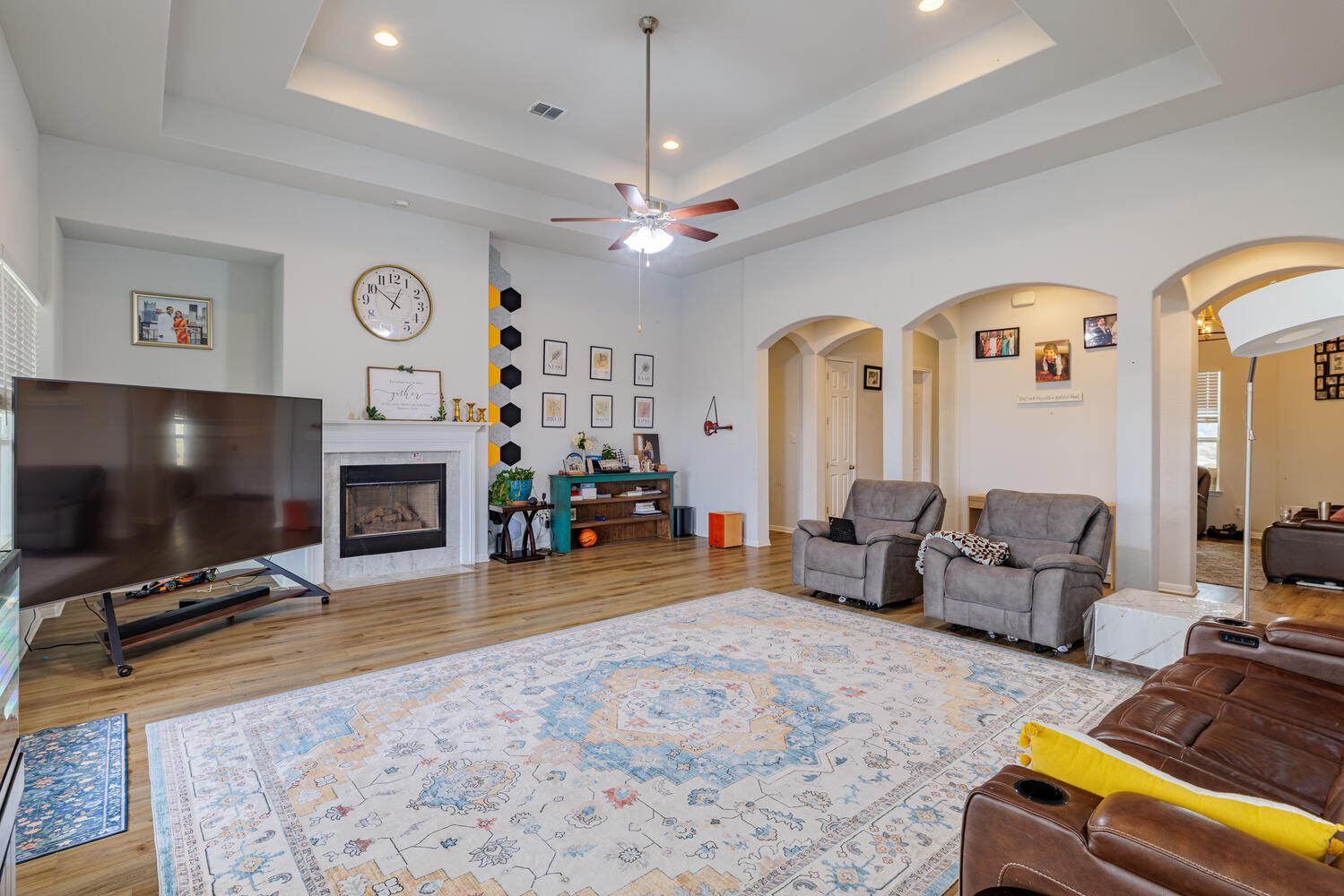 1913 Equine Road Leander, TX 78641 - Photo 9 of 35 a living room with furniture a flat screen tv and a fireplace