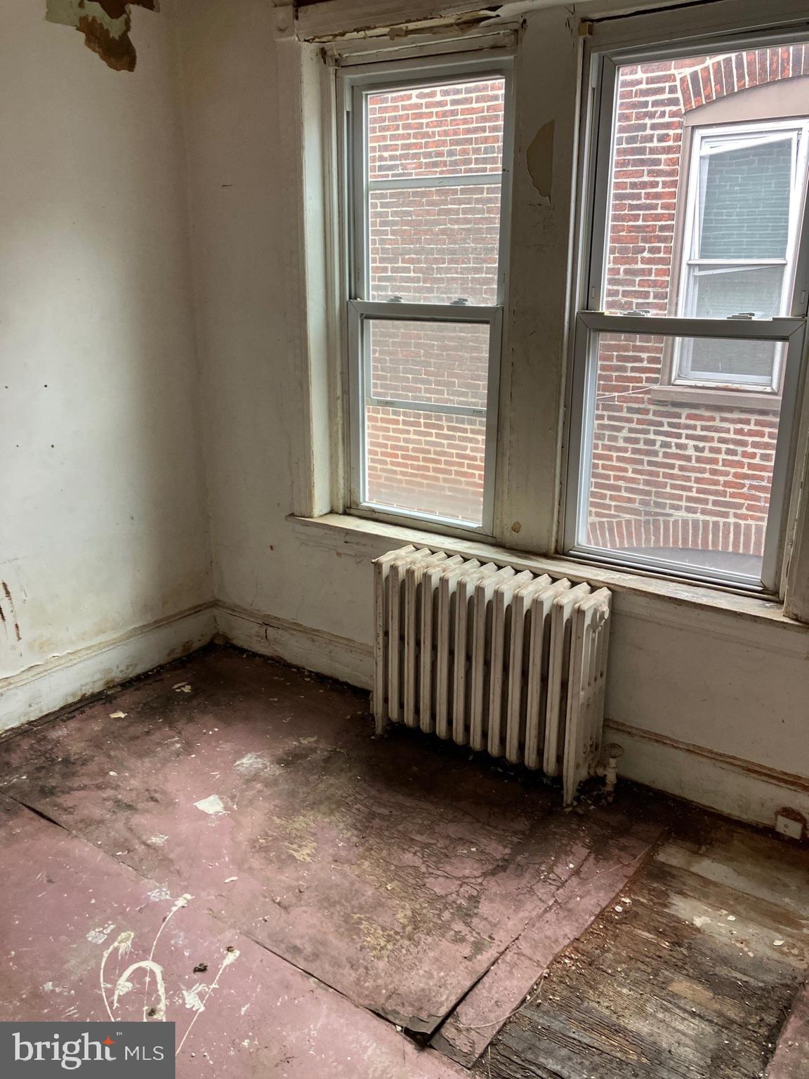 1233 Crosby Street Chester, PA 19013 - Photo 24 of 30 a view of a room with exposed radiator and a window