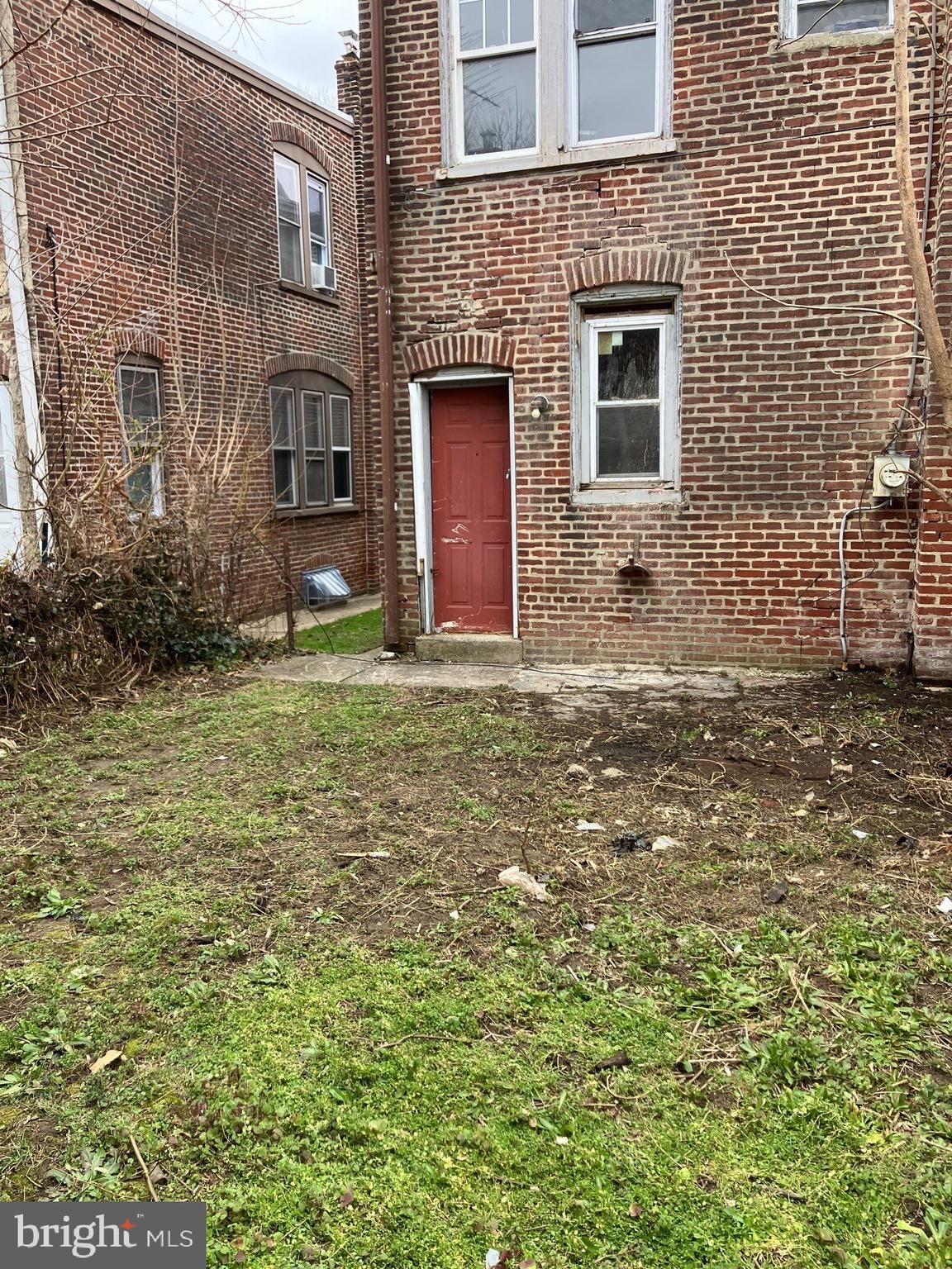 1233 Crosby Street Chester, PA 19013 - Photo 3 of 30 a large brick house with a yard