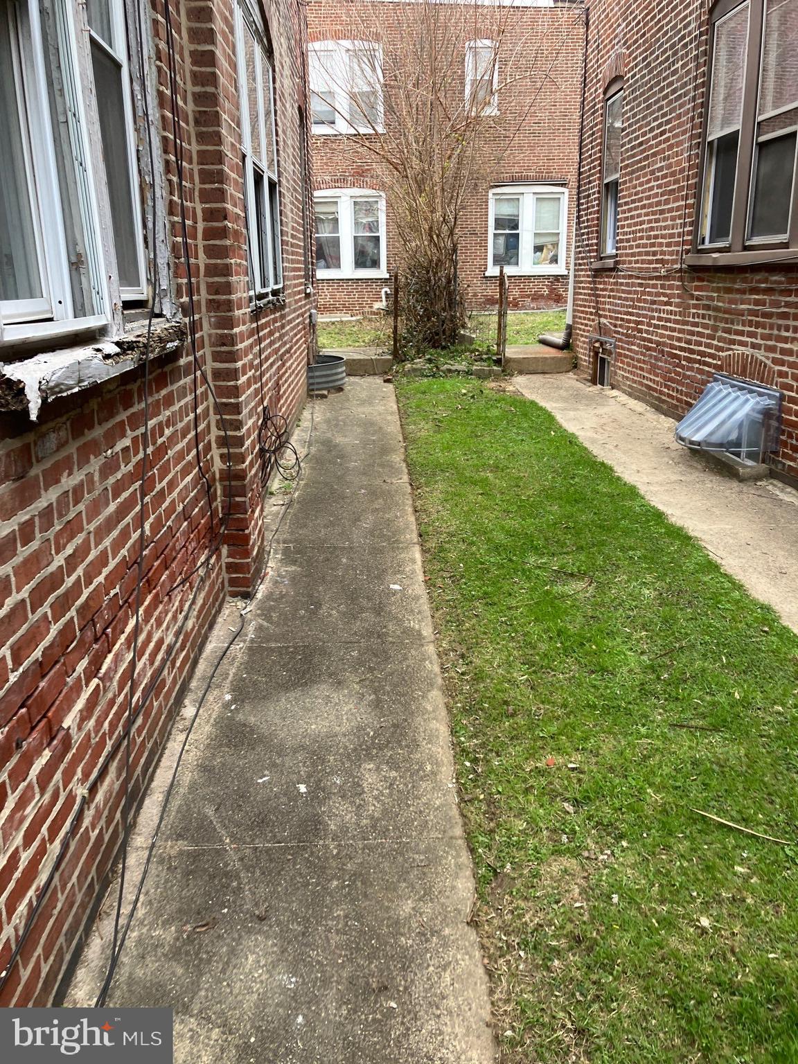 1233 Crosby Street Chester, PA 19013 - Photo 4 of 30 a view of a backyard with couches plants and large trees