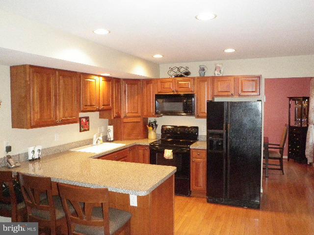 515 Tulip Road Riva, MD 21140 - Photo 11 of 30 a kitchen with stainless steel appliances granite countertop a refrigerator a stove top oven a sink and dishwasher