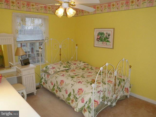 515 Tulip Road Riva, MD 21140 - Photo 23 of 30 a bed sitting in a bedroom next to a bathroom