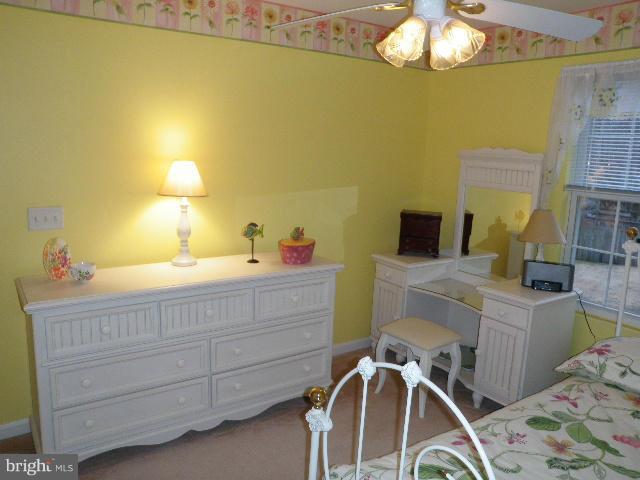 515 Tulip Road Riva, MD 21140 - Photo 24 of 30 a bedroom with a bed and a chandelier