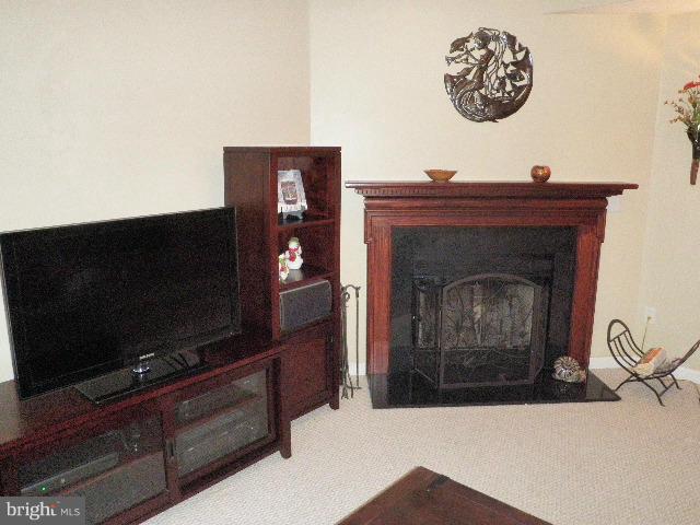 515 Tulip Road Riva, MD 21140 - Photo 6 of 30 a living room with a fireplace and a flat screen tv