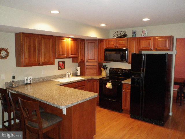 515 Tulip Road Riva, MD 21140 - Photo 10 of 30 a kitchen with stainless steel appliances a stove refrigerator sink and cabinets