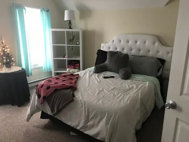 a bed sitting in a bedroom next to a window