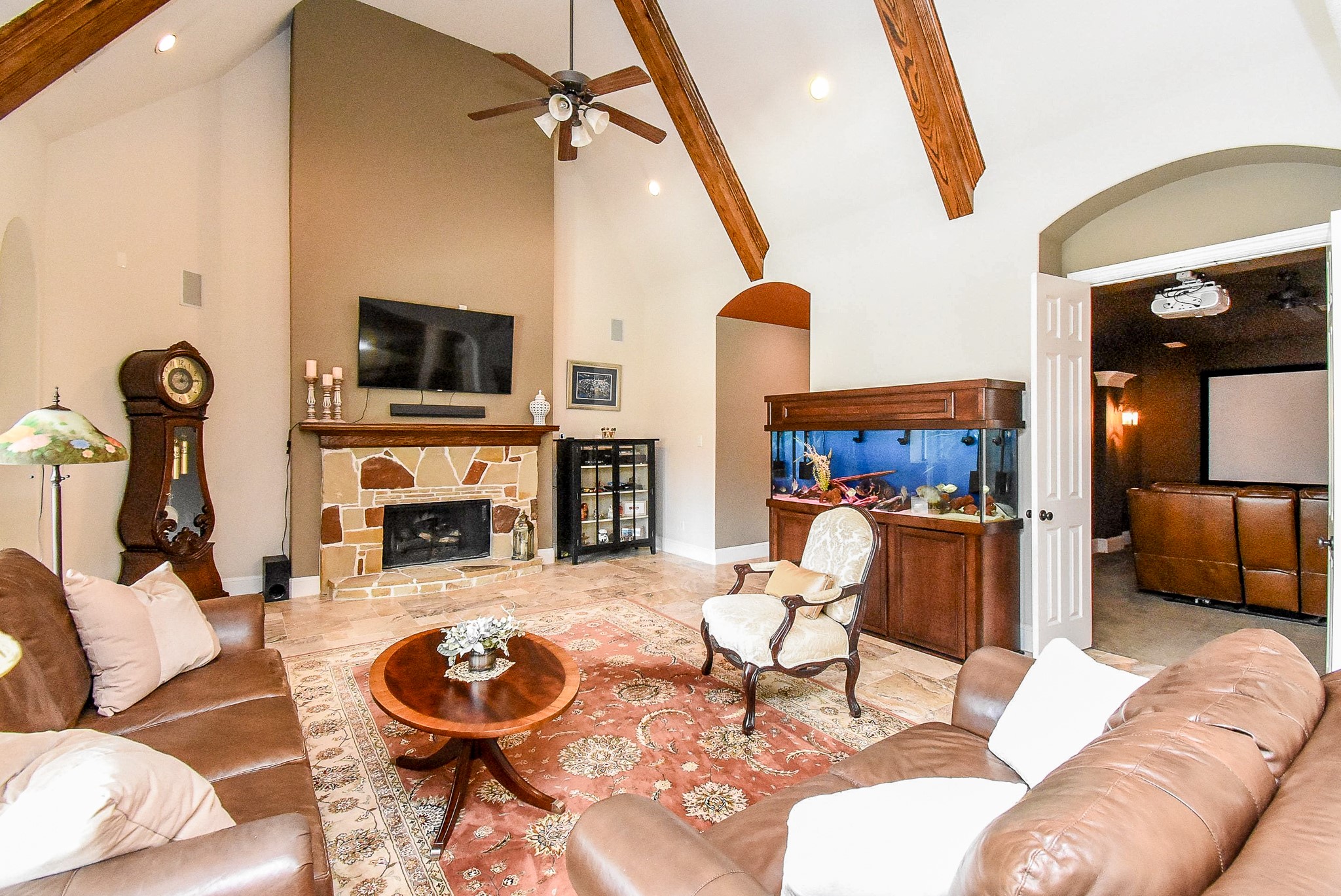 27427 Guthrie Ridge Lane Katy, TX 77494 - Photo 17 of 48 a living room with furniture a fireplace and a flat screen tv