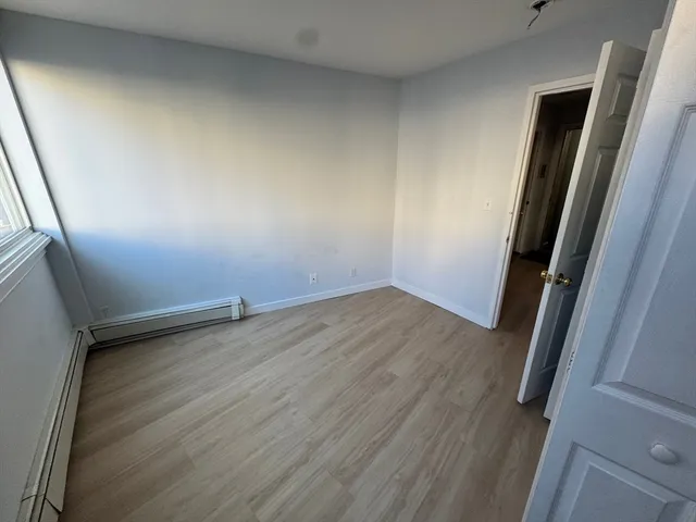 an empty room with wooden floor