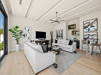 a spacious bedroom with a bed and a flat screen tv