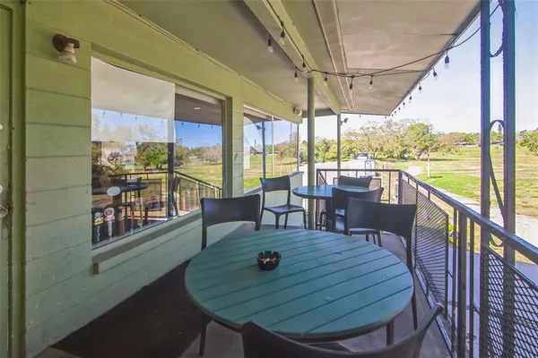 a view of a patio with a table chairs and balcony