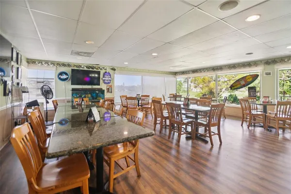 a view of a dining room with furniture window and wooden floor