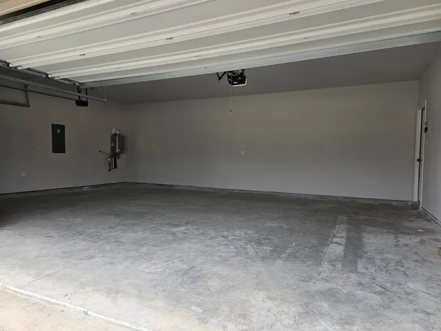 a view of backyard with white house and a large window
